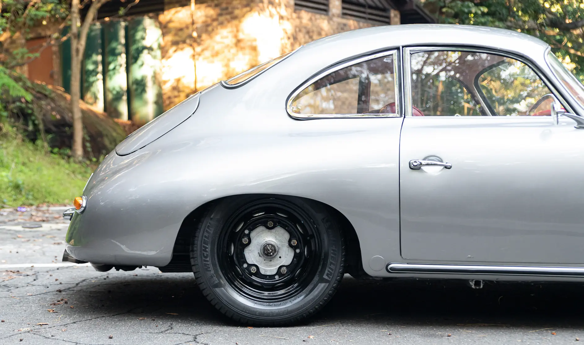 Silver Porsche 356 in a driveway